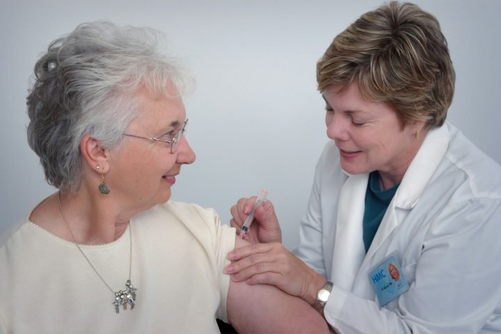 Care worker supporting a smiling older woman