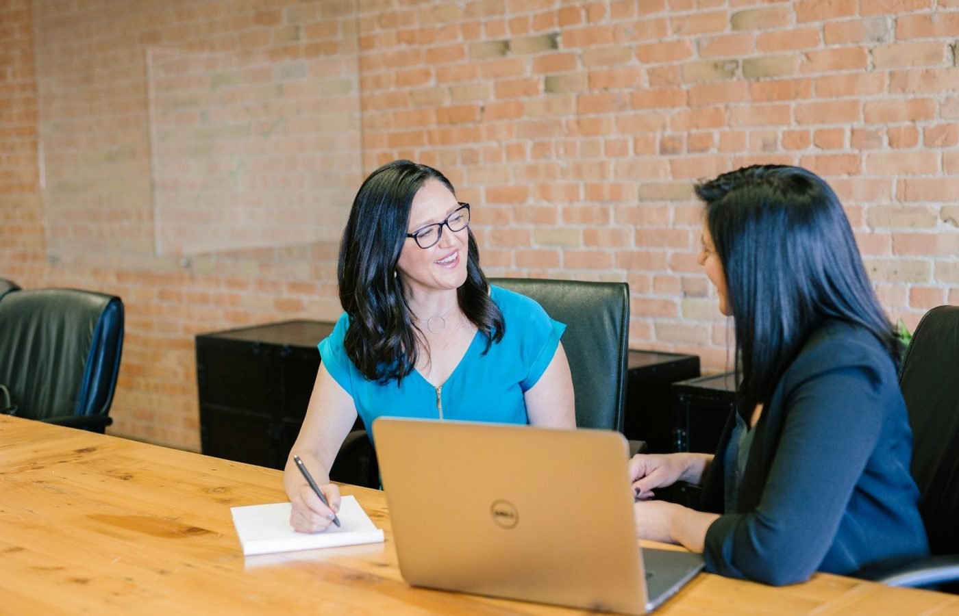 Two women talking across a table during an interview