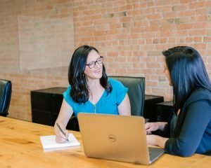 Two women talking across a table during an interview