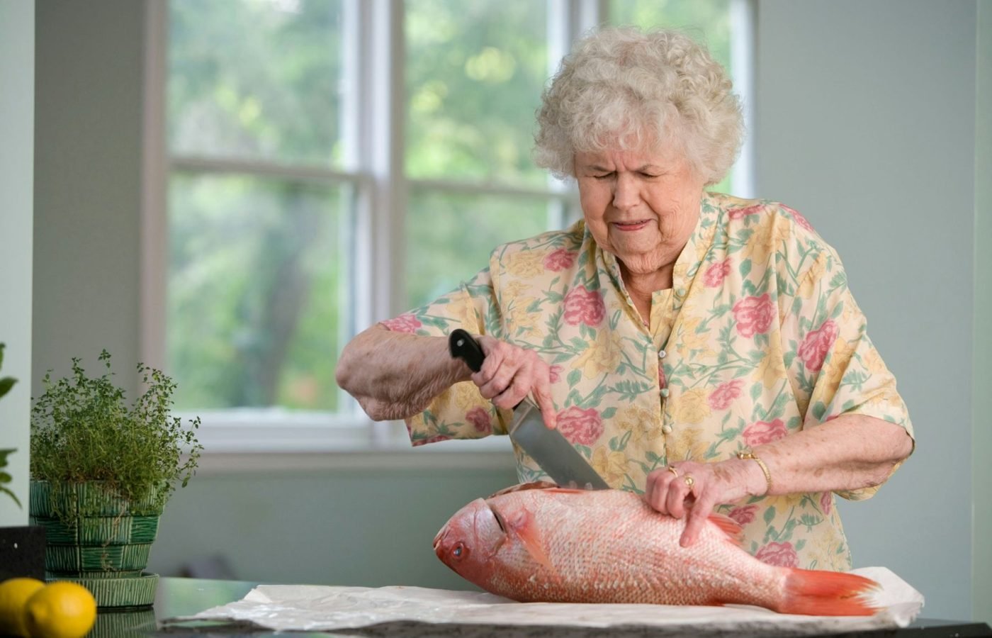 Older woman preparing a meal in her own kitchen