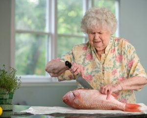 Older woman preparing a meal in her own kitchen