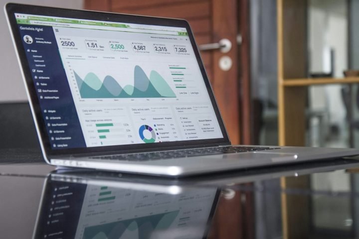 Laptop on a desk showing a website analytics dashboard