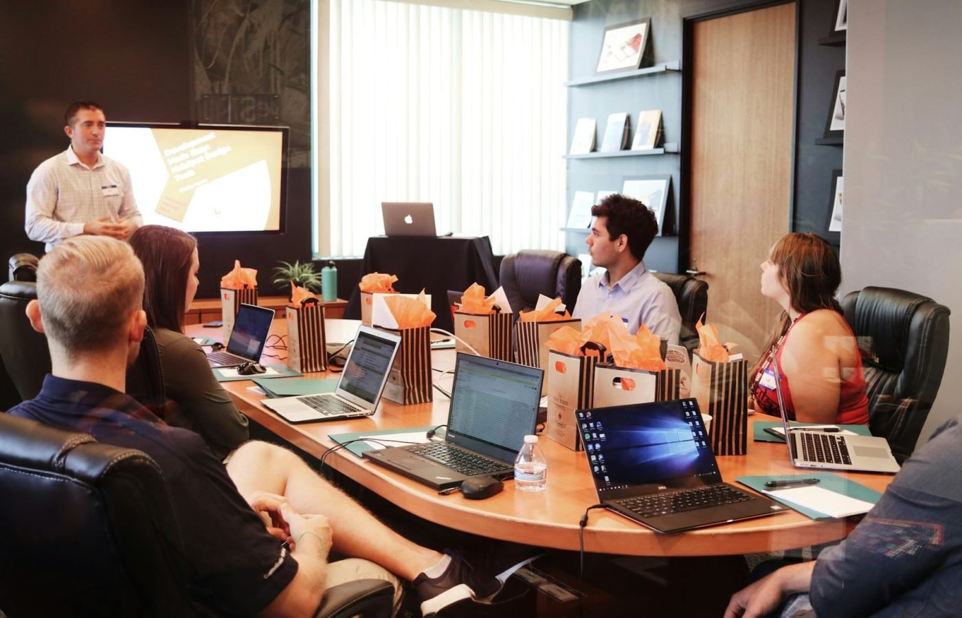 Group training session around a table with laptops