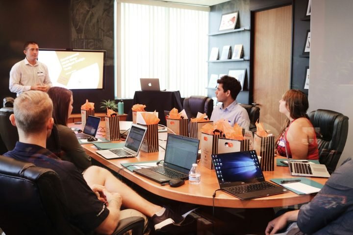 Group training session around a table with laptops