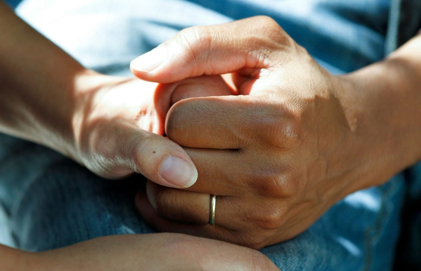 Two people holding hands in a gesture of support